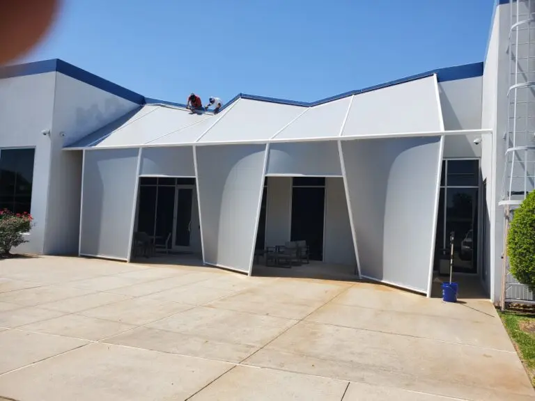 Modern building with angular white awnings.