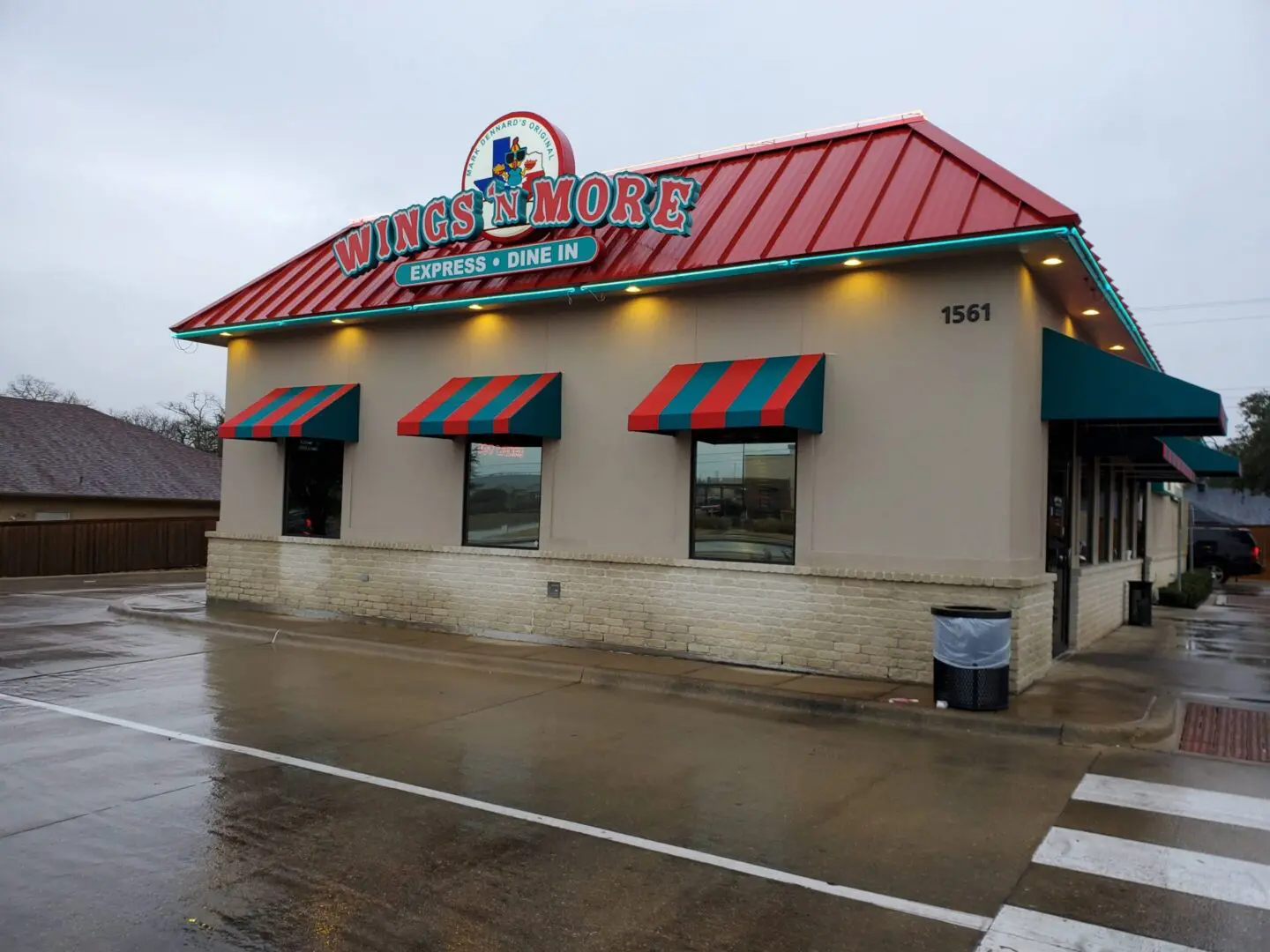Exterior of a Krispy Kreme store on a rainy day.