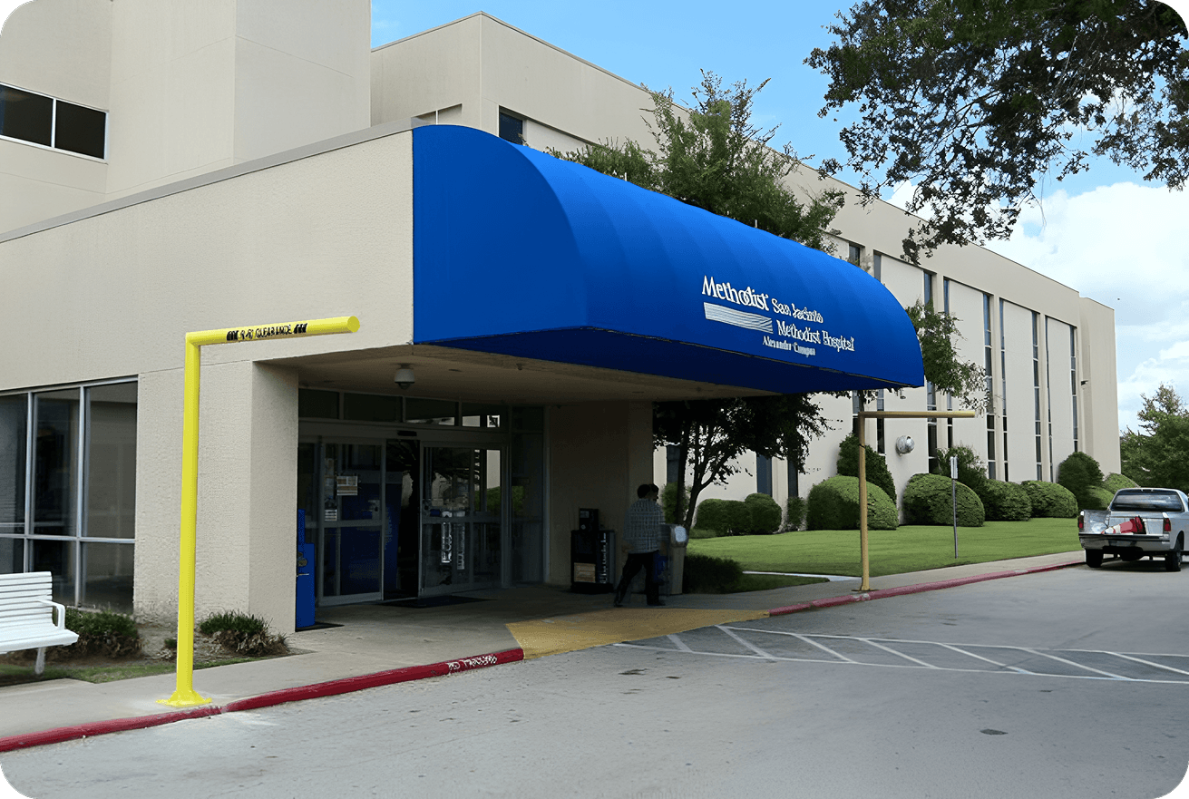 Entrance of a medical center with a blue awning and clear signage.